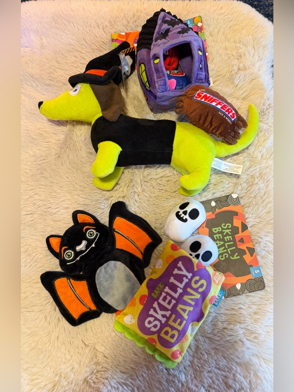 festive 4 piece set of Halloween-themed plush dog toys